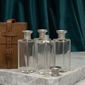 Leather Cased Set of Silver Top Bottles