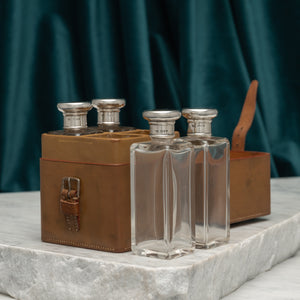 Leather Cased Set of Silver Top Bottles