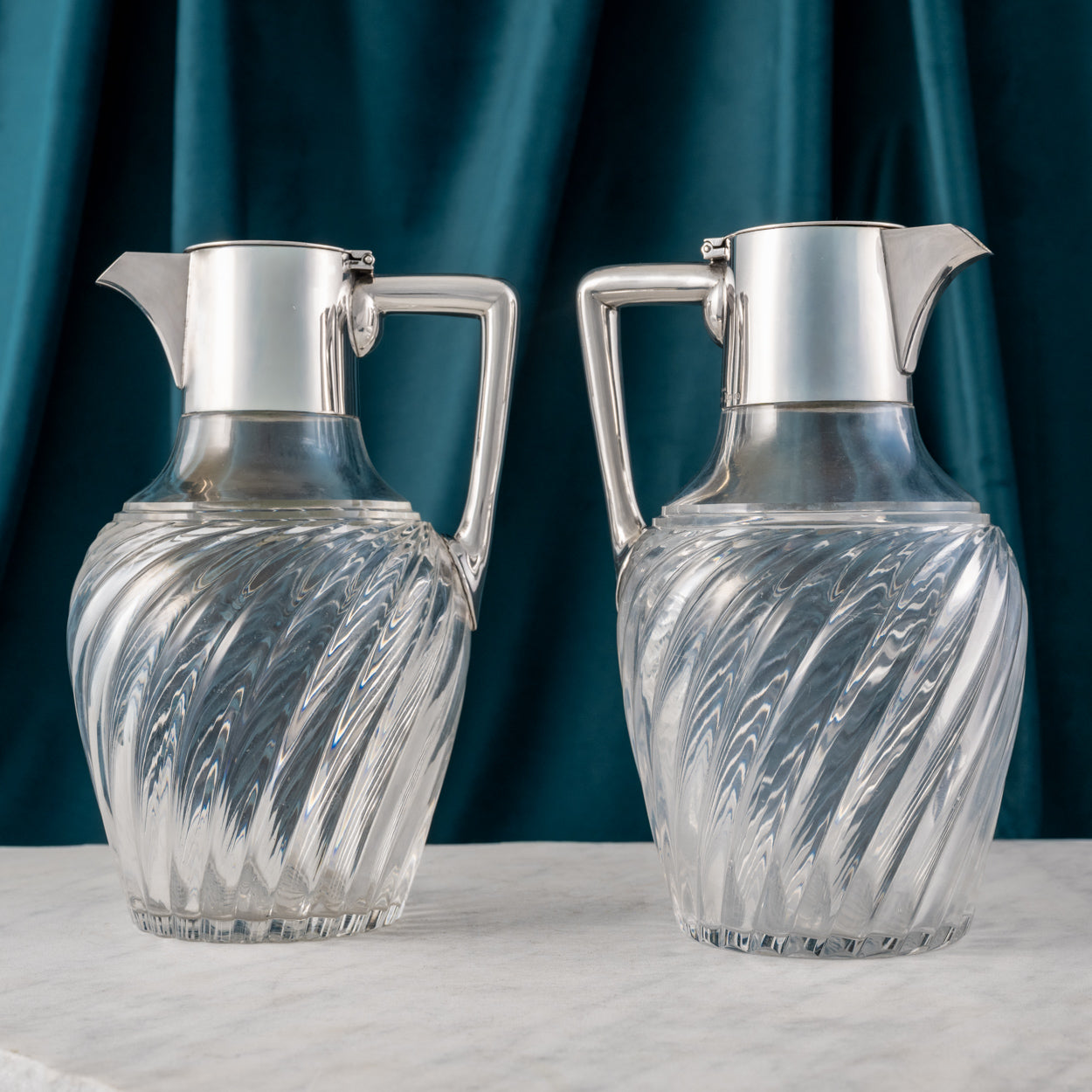 Pair of Silver Topped Cut Glass Claret Jugs