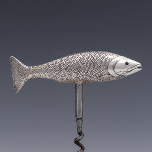 Side view of a corkscrew with the handle in the form of a salmon with the tail on the left and the head on the right. Cast in silver and beautifully detailed, showing the mouth, fins and even the scales. The fish is modelled as if 'on the move' so it sits in the hand very comfortably when the corkscrew is in use. 