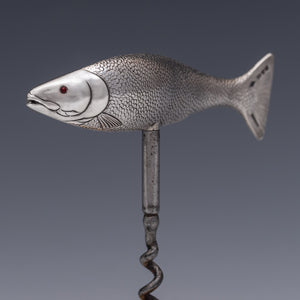 Front three quarter view of a corkscrew with the handle in the form of a salmon cast in silver and beautifully detailed, showing the mouth, fins and even the scales. The fish is modelled as if 'on the move' so it sits in the hand very comfortably when the corkscrew is in use. 