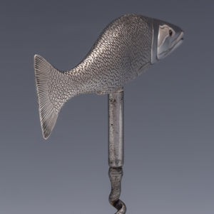 Rear three quarter view of a corkscrew with the handle in the form of a salmon cast in silver and beautifully detailed, showing the mouth, fins and even the scales. The fish is modelled as if 'on the move' so it sits in the hand very comfortably when the corkscrew is in use. 