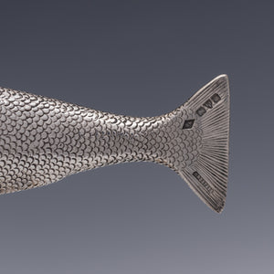 Side view of the tail of a salmon modelled in silver that is the handle of a corkscrew. It is stamped with registered design number, maker's mark for silversmith Henry Wells and hallmarks for Chester 1914. 