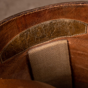 A close up image showing the makers name stamped into the leather inside of the pair of brown leather polo boots, made for Earl Spencer, Althorp Estate. 