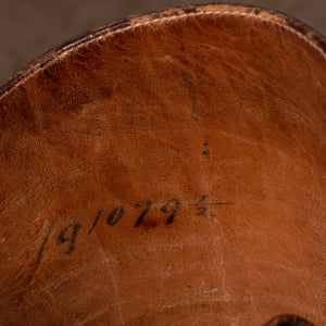 A close up image showing the serial number written inside of the pair of brown leather polo boots including their wooden trees, made for Earl Spencer, Althorp Estate. 