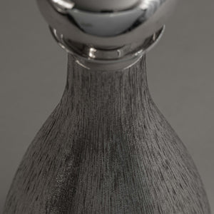 Close up of the hallmark on silver 'bark finish' decanter by House of Lawrian, London 1973. Detail of engraved silver bark finish.