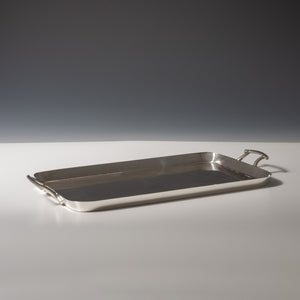 Walker and Hall silver plated rectangular tray with raised edges viewed from the side with a handle each end. White and grey set at a diagonal.