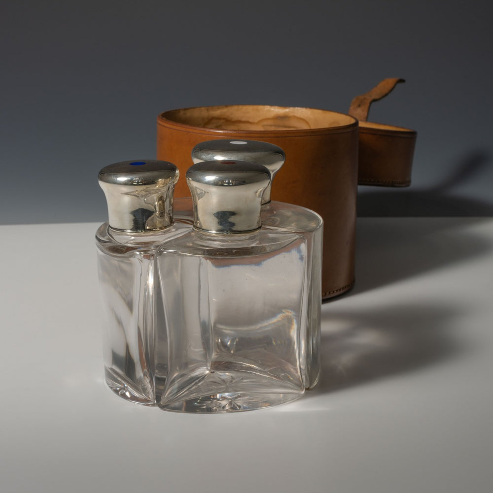 Leather Cased Silver and Enamel Top Bottles